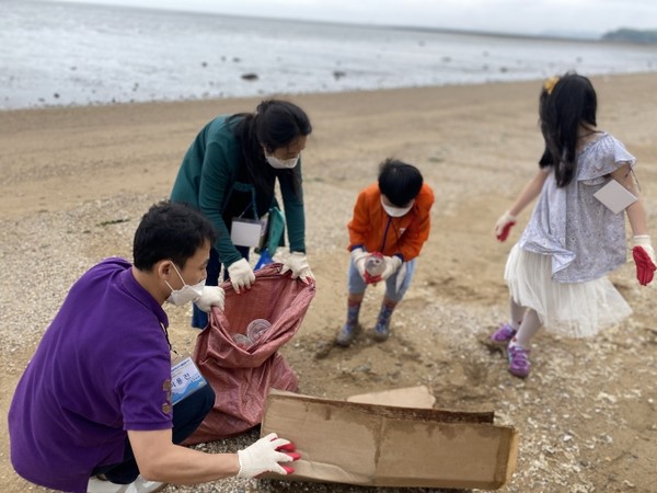 '착한가치 비치코밍' 참여 가족이 화성 궁평항에서 쓰레기를 주워 모으고 있다.  사진=경기도 제공