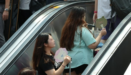 폭염경보가 지속되는 가운데 8월 4일 서울역 행인들이 연신 부채질을 하고 있다. 사진=연합