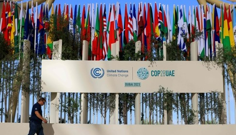 한 남성이 11월 30일(현지시간) 아랍에미리트(UAE) 두바이의 제28차 유엔기후변화협약 당사국 총회(COP28) 행사장에 세워진 참가국들의 국기를 지나치고 있다. AFP=연합