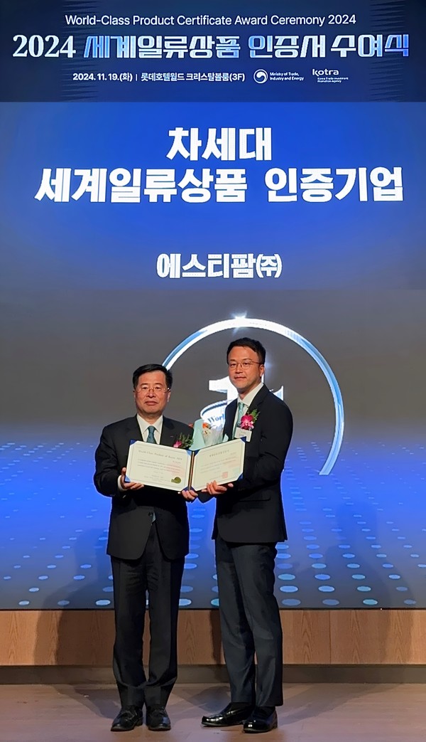 에스티팜이 차세대 세계일류상품 생산기업으로 선정돼 인증서를 수여 받았다. 왼쪽부터 KOTRA 강경성 사장, 에스티팜 김이환 상무.   사진=에스티팜